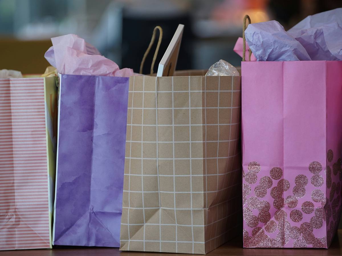 A row of colourful paper shopping bags