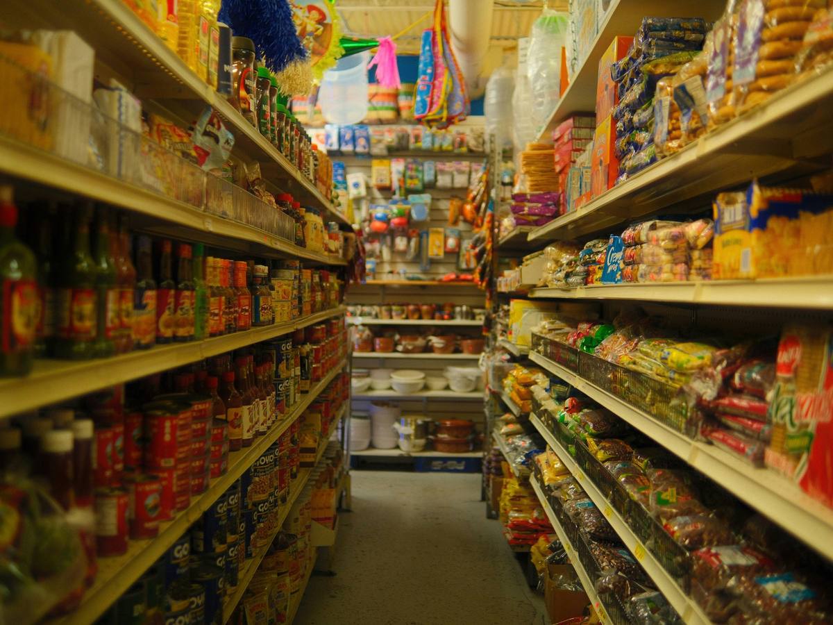 A grocery aisle with full shelves on both sides