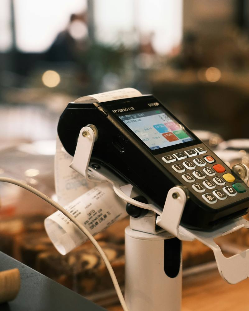 A card terminal on a stand at a café counter